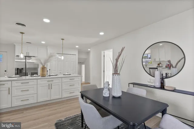 a kitchen with a table chairs sink and cabinets