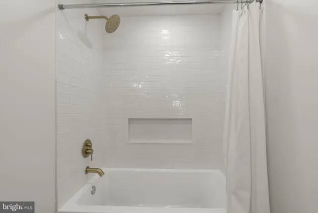 a view of an empty room and wooden floor