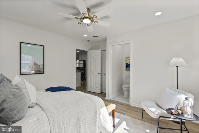 a bed room with a bed and painting on the wall