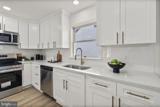 a kitchen with white cabinets and a stove