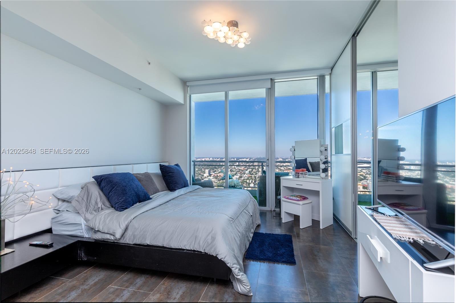 92 Southwest 3rd Street, Unit 5108 Miami, FL 33130 - Photo 13 of 33 a bedroom with a bed and a view of kitchen