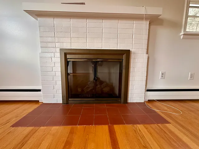 a view of a fireplace with an empty room