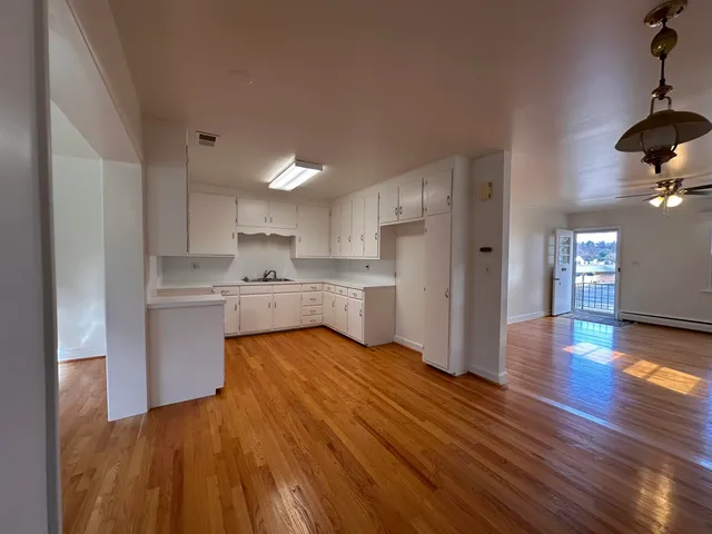 a view of kitchen with wooden floor and electronic appliances