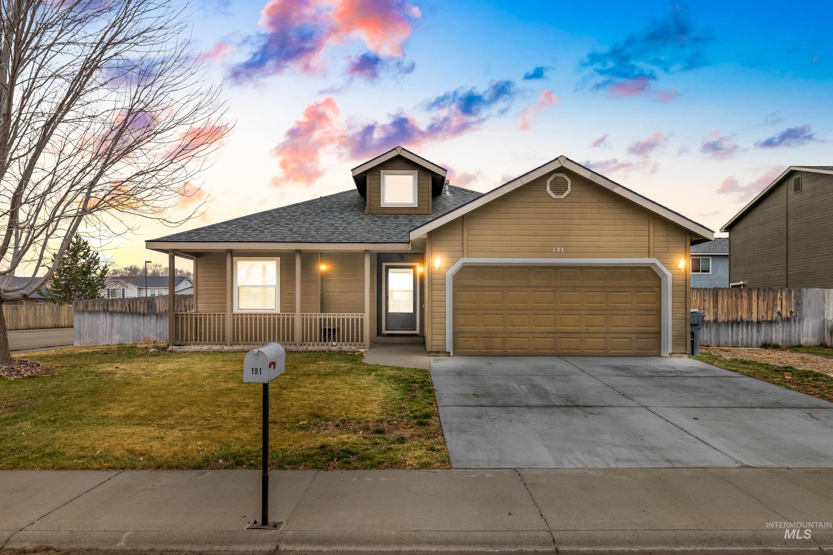View of front of property with covered porch, driveway, a shingled roof, and an attached garage