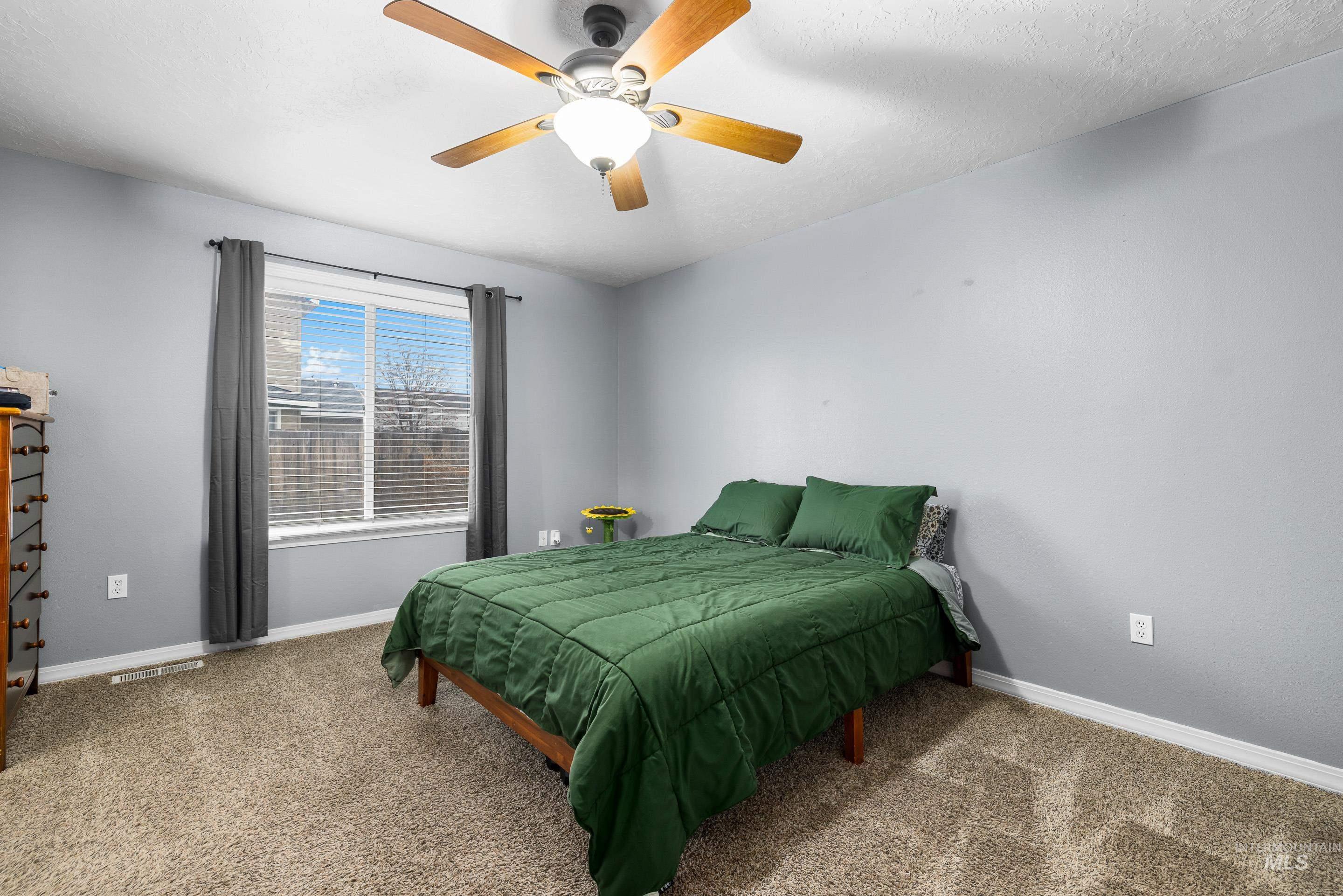 191 Southwest Quaker Drive Mountain Home, ID 83647 - Photo 23 of 43 Carpeted bedroom with baseboards and a ceiling fan
