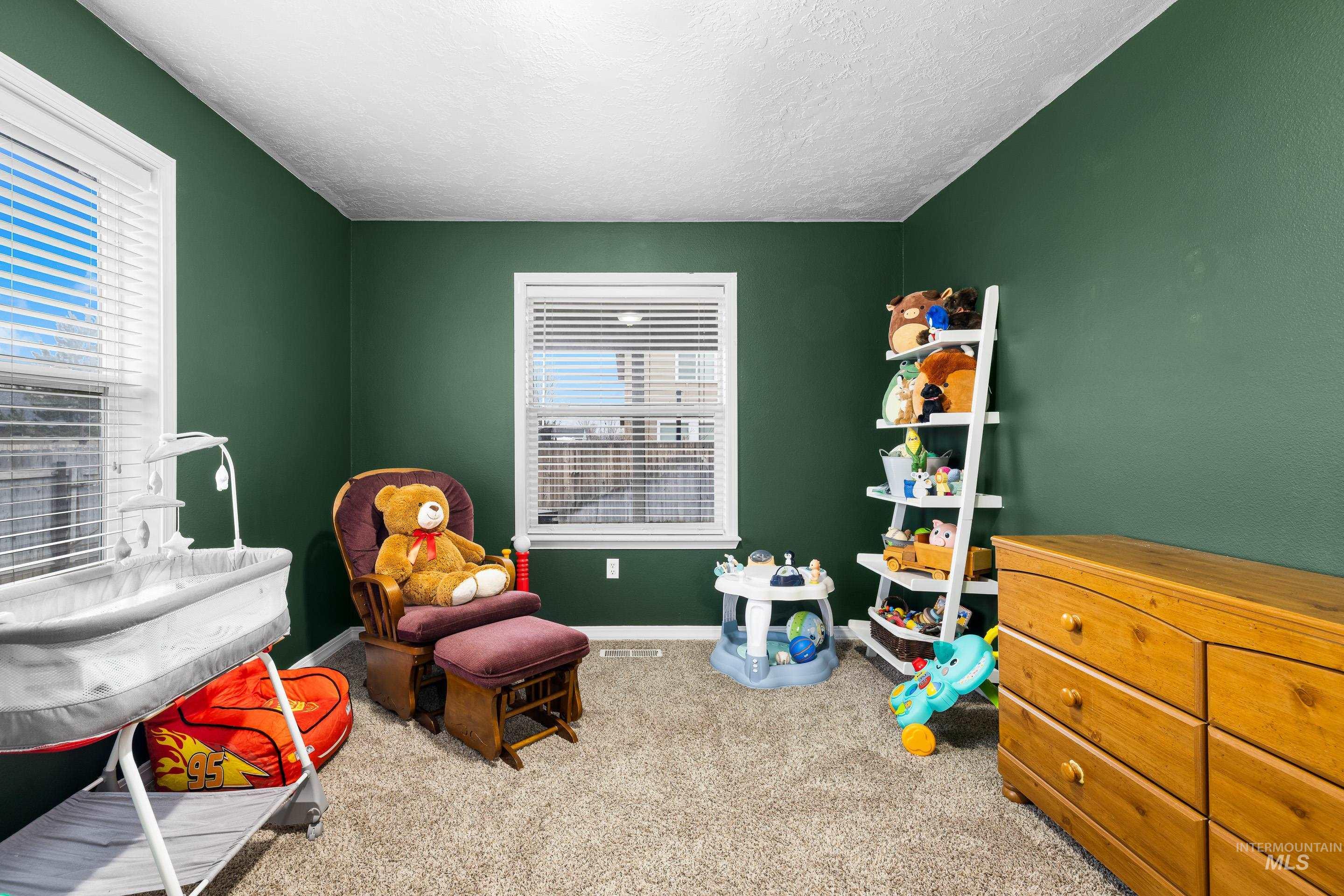 191 Southwest Quaker Drive Mountain Home, ID 83647 - Photo 33 of 43 Playroom featuring light colored carpet and a textured ceiling