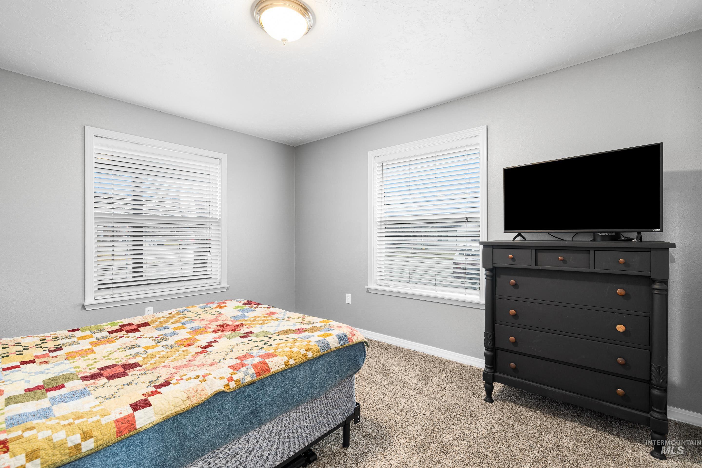 191 Southwest Quaker Drive Mountain Home, ID 83647 - Photo 35 of 43 Bedroom with baseboards and light colored carpet