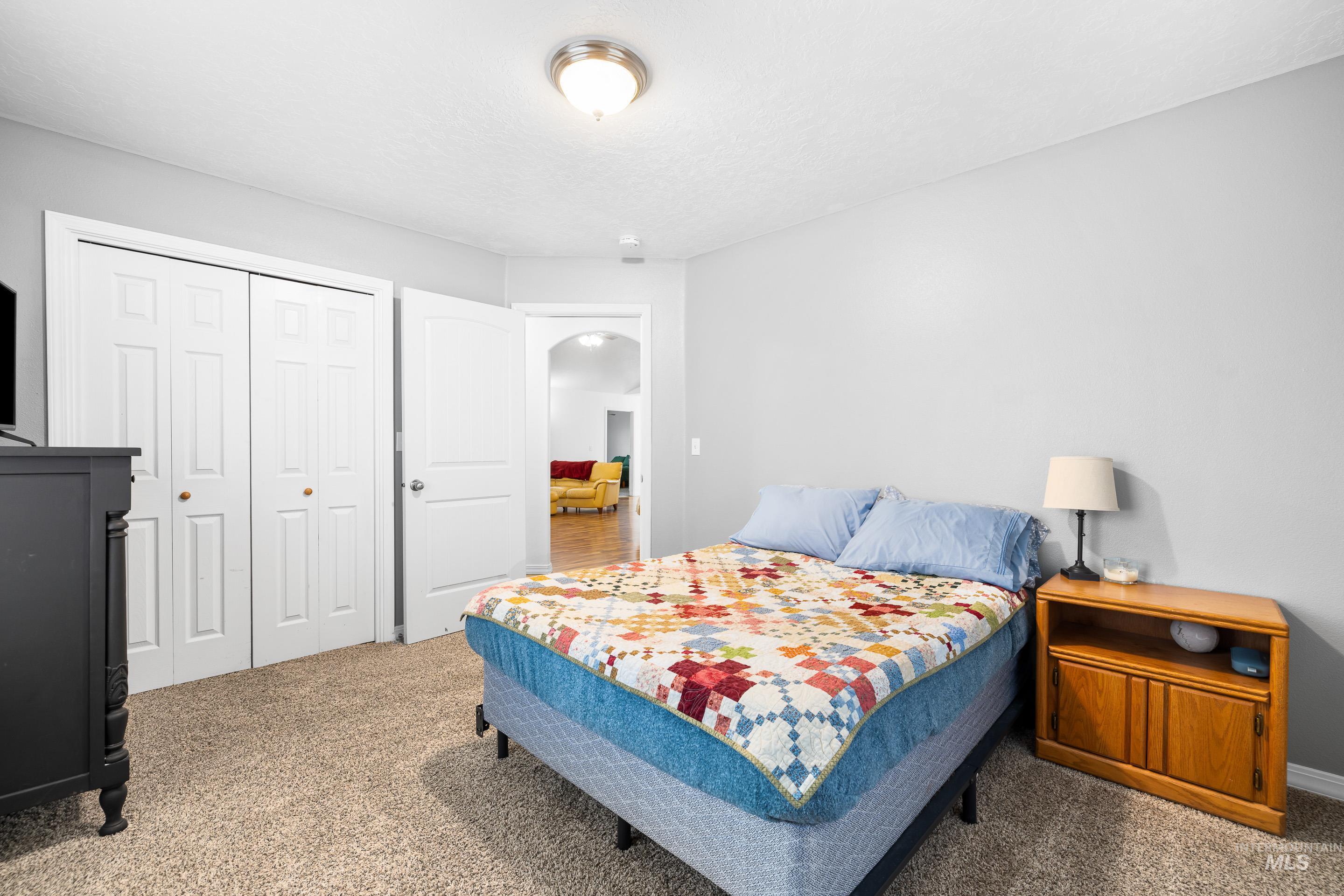 191 Southwest Quaker Drive Mountain Home, ID 83647 - Photo 36 of 43 Bedroom with a closet, carpet, and arched walkways