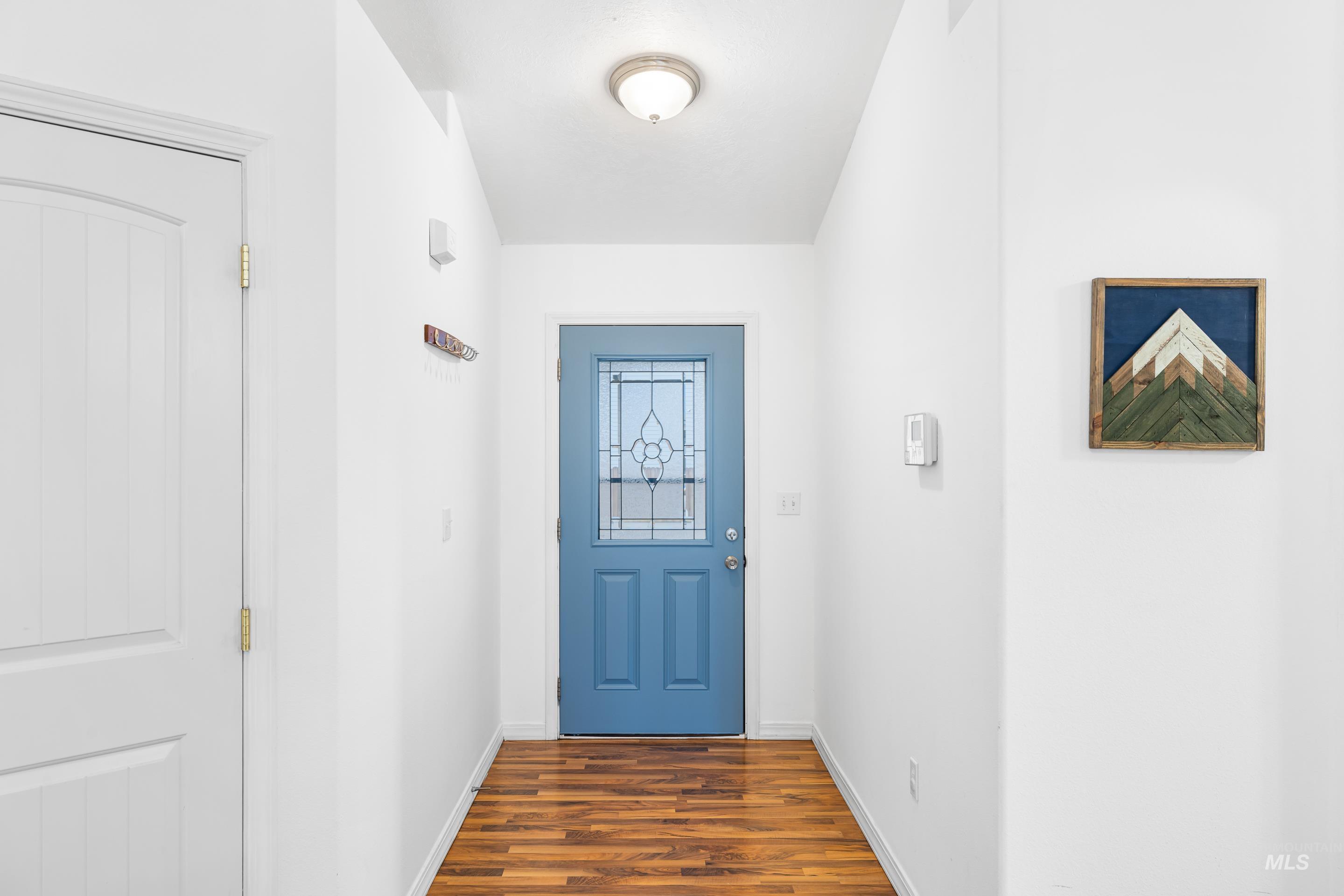 191 Southwest Quaker Drive Mountain Home, ID 83647 - Photo 6 of 43 Doorway to outside with wood finished floors and baseboards