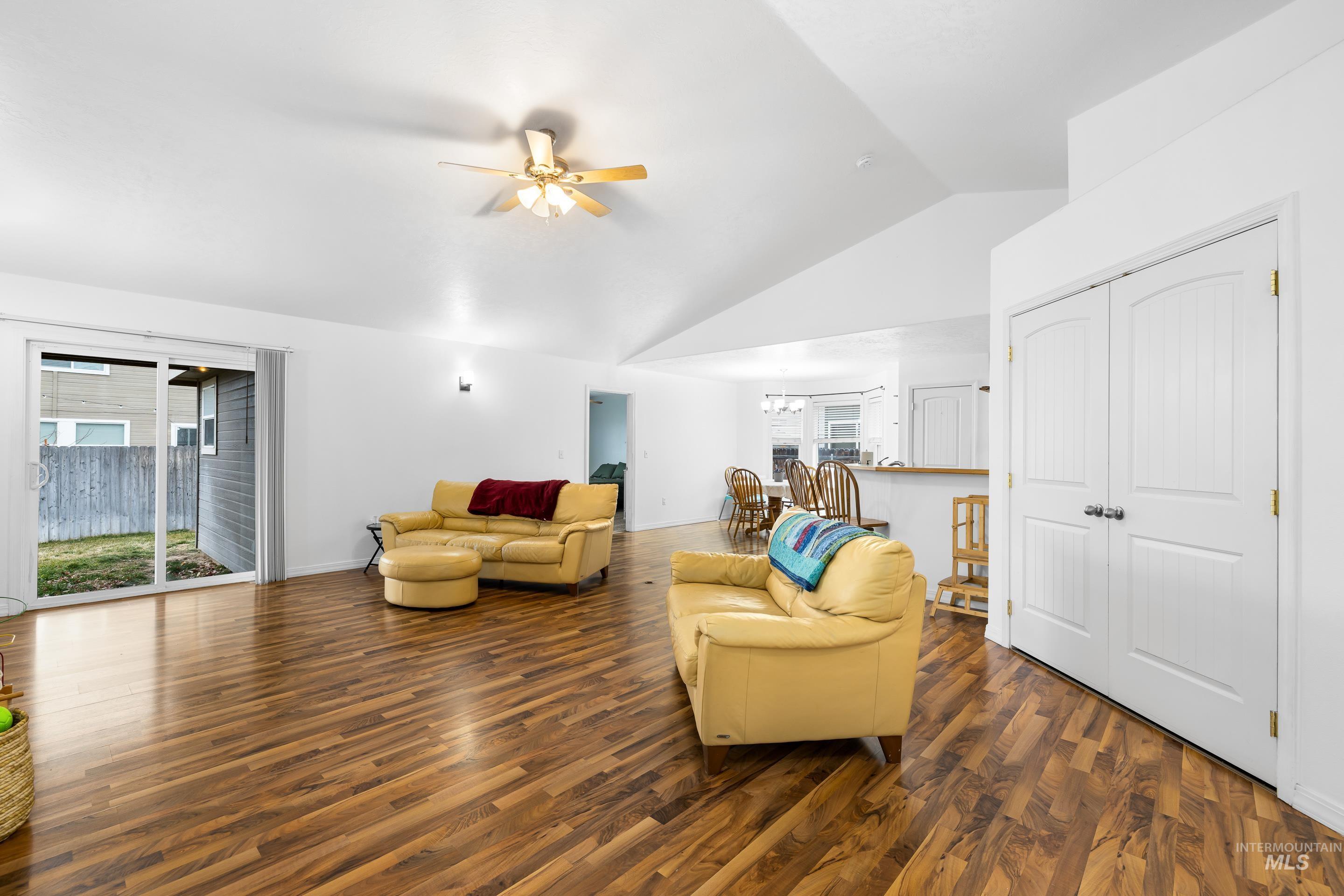 191 Southwest Quaker Drive Mountain Home, ID 83647 - Photo 8 of 43 Living area with dark wood-type flooring, a ceiling fan, healthy amount of natural light, and high vaulted ceiling