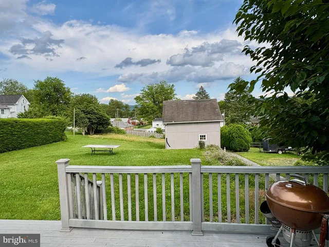 a front view of a house with a yard table and chairs