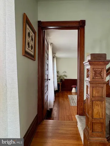 a view of a hallway and a livingroom with furniture
