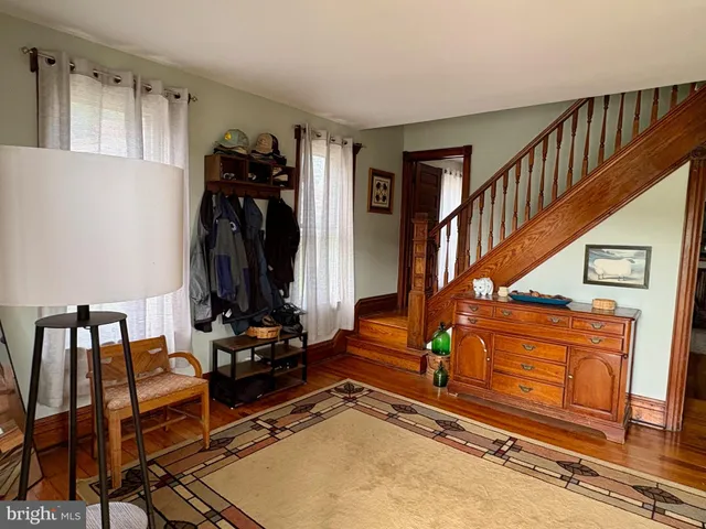 a view of gym equipment and living room with wooden floor