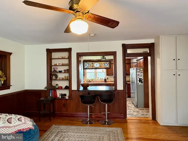 a work room with furniture and wooden floor