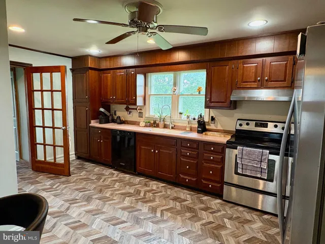 a kitchen with a stove a sink and a refrigerator