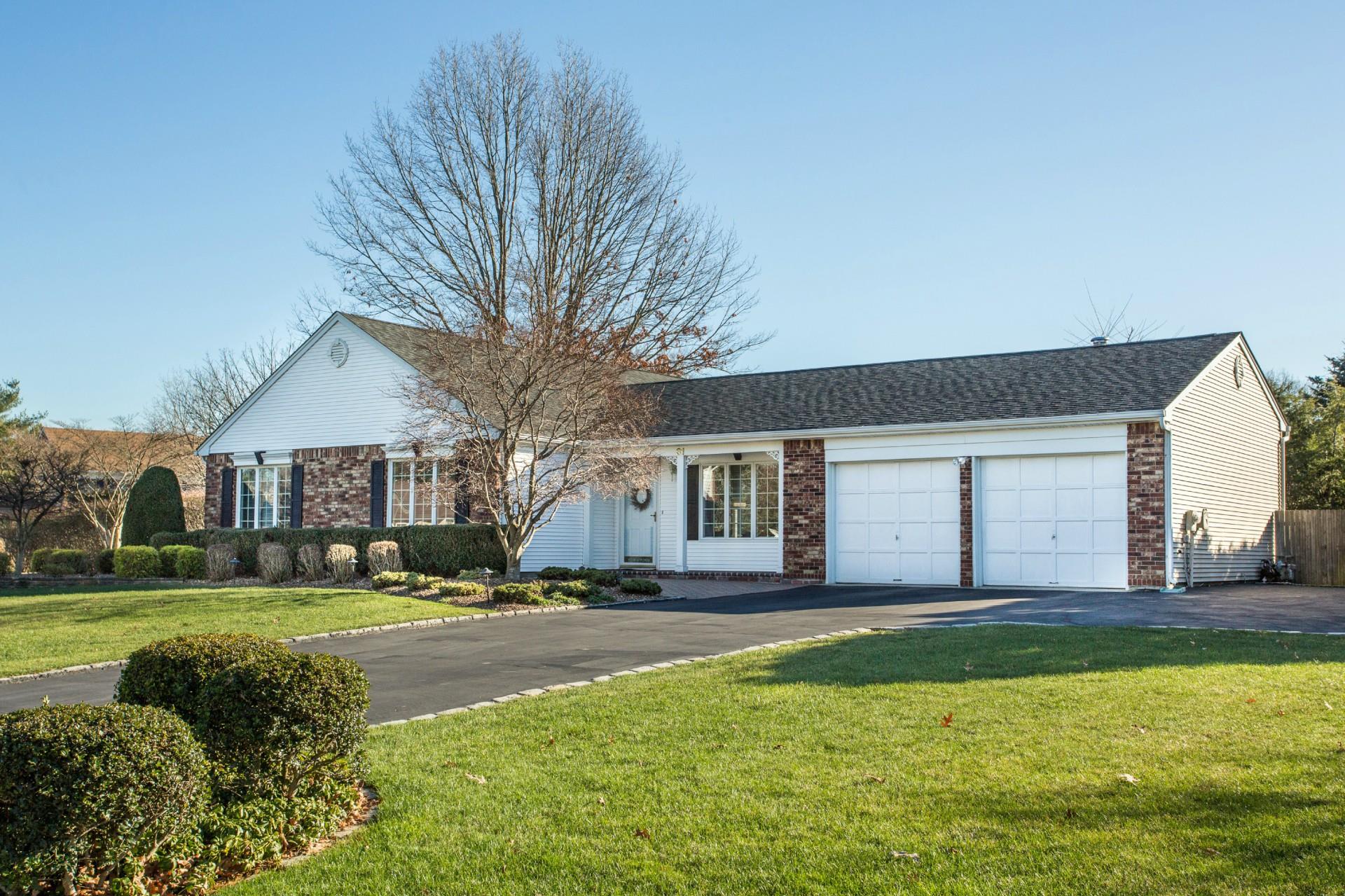 31 Timber Ridge Drive Commack, NY 11725 - Photo 1 of 1 Ranch-style home featuring an attached garage, a front lawn, aphalt driveway, and brick siding