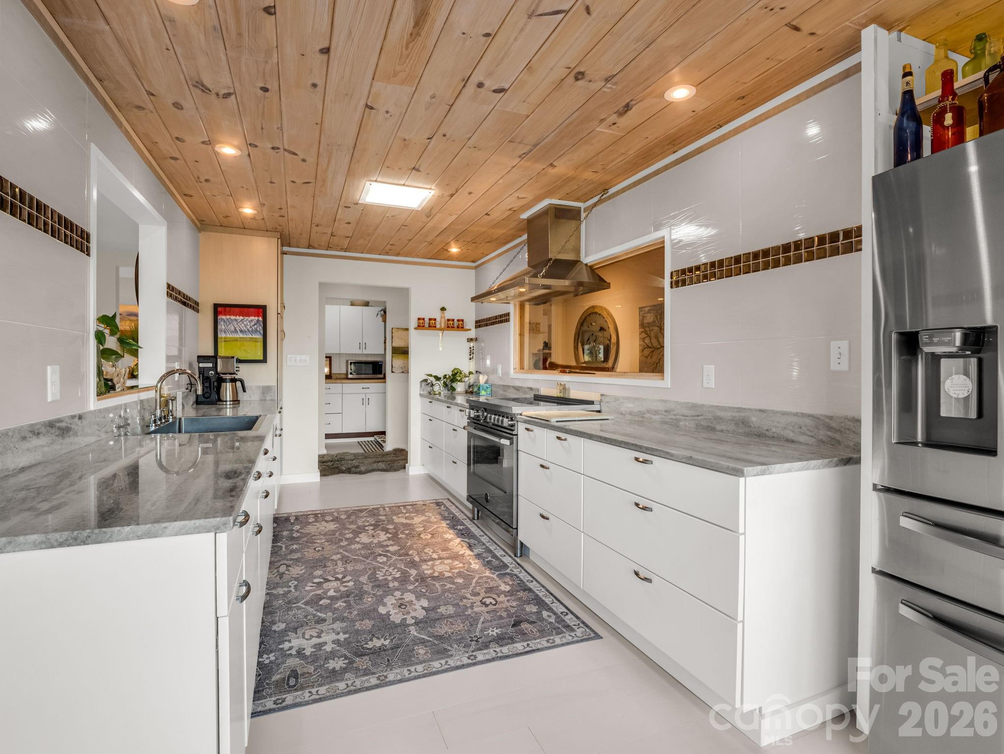 200 Piney Mountain Road Tryon, NC 28782 - Photo 15 of 48 a large kitchen with stainless steel appliances granite countertop a sink stove and refrigerator