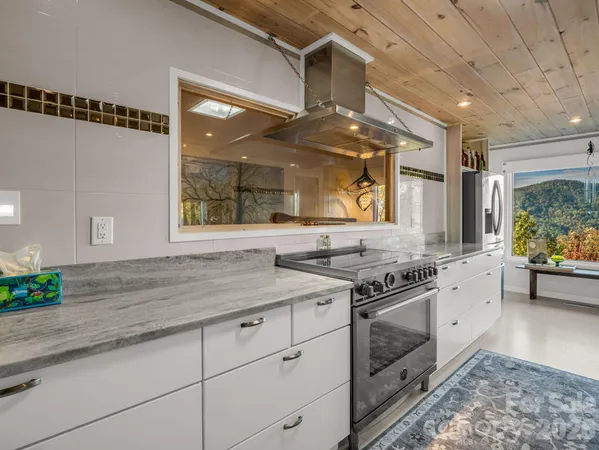 a kitchen with stainless steel appliances granite countertop a stove and a sink