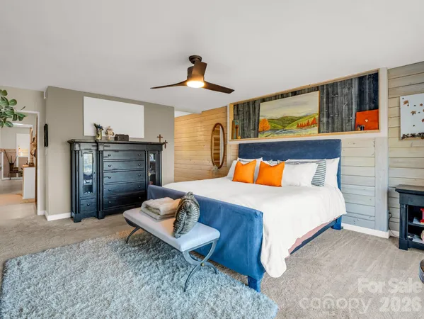 a bedroom with a bed and dresser