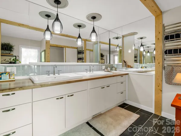 a spacious bathroom with a double vanity sink mirror and