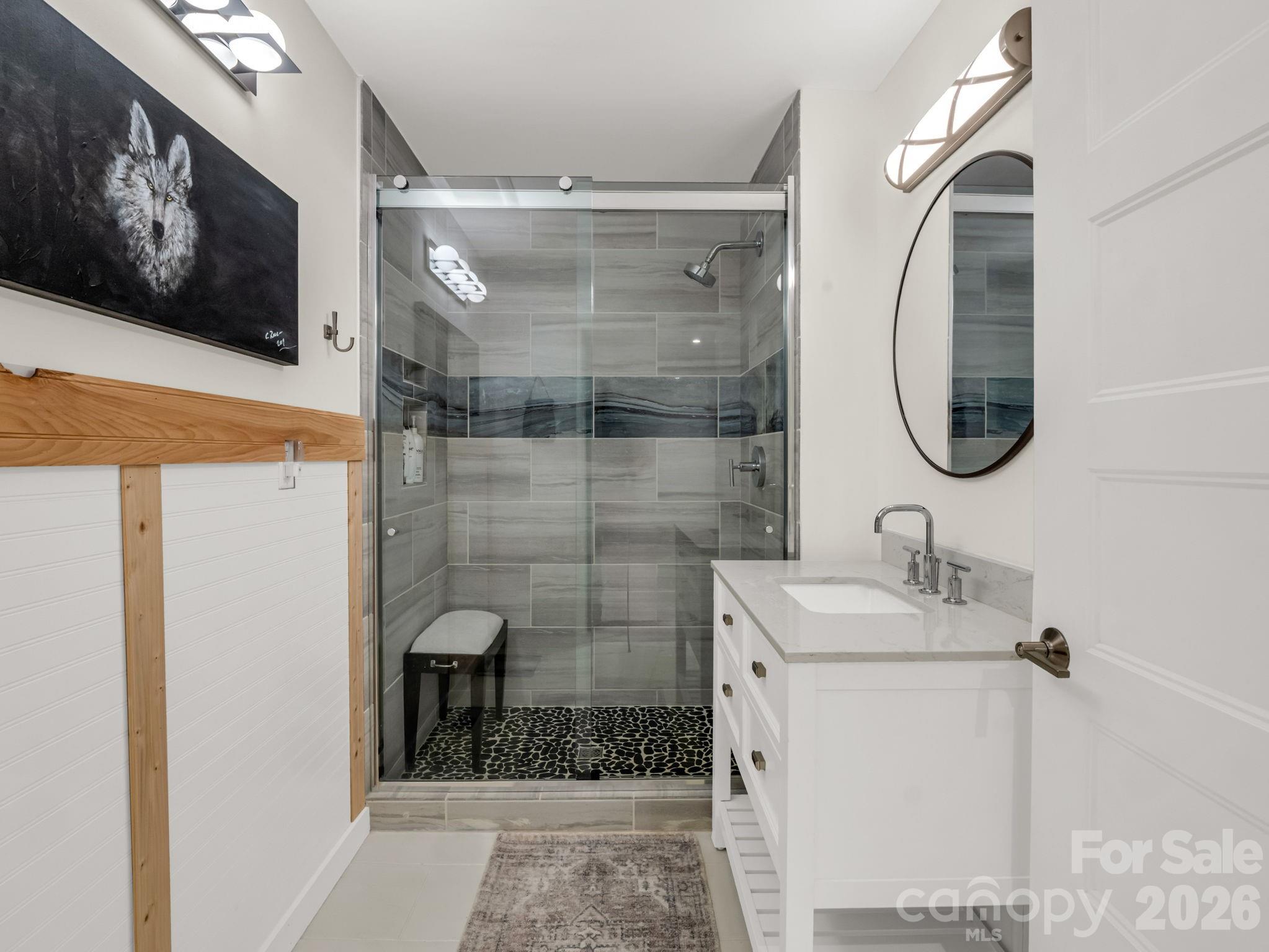 200 Piney Mountain Road Tryon, NC 28782 - Photo 32 of 48 a bathroom with a sink a mirror and a shower