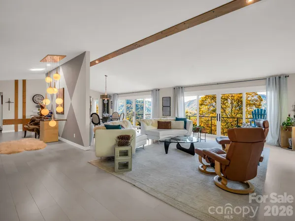 a living room with furniture and large windows