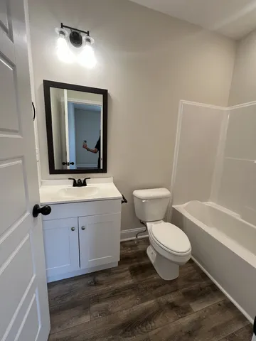 a bathroom with a toilet and a bathtub