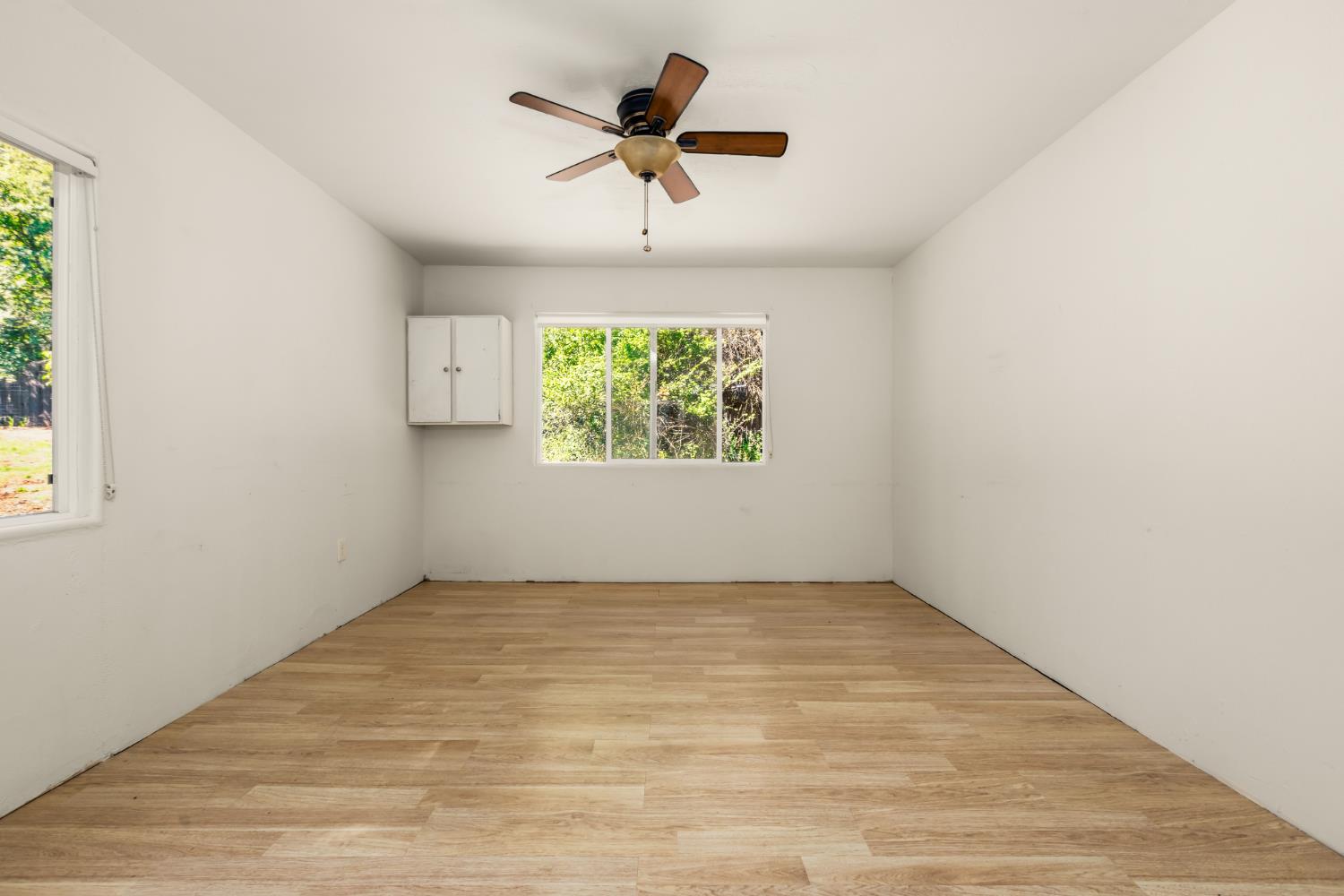 10875 Spenceville Road Penn Valley, CA 95946 - Photo 38 of 49 an empty room with window ceiling fan and windows