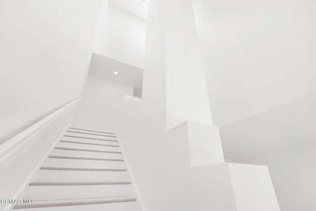 a view of an empty room and fire place