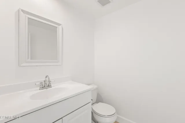 a view of kitchen with cabinets