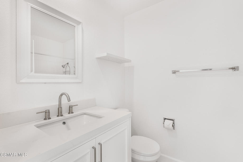 4240 Lost Hills Road, Unit 802 Calabasas, CA 91301 - Photo 35 of 49 a bathroom with a sink mirror vanity and toilet
