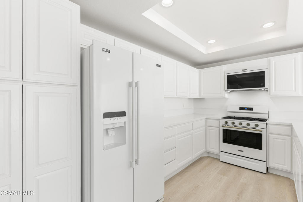 4240 Lost Hills Road, Unit 802 Calabasas, CA 91301 - Photo 4 of 49 a kitchen with stainless steel appliances a refrigerator stove and microwave