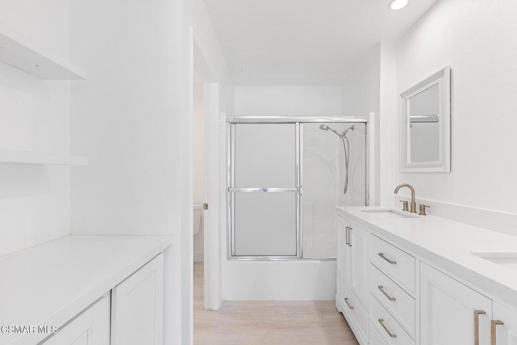 4240 Lost Hills Road, Unit 802 Calabasas, CA 91301 - Photo 45 of 49 a bathroom with a granite countertop sink a toilet and shower