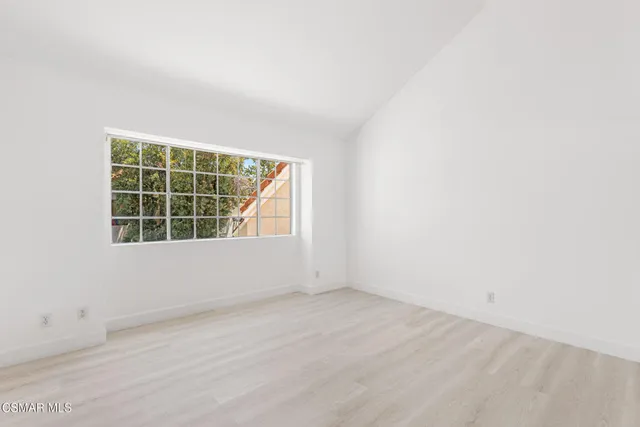 a bedroom with a large bed and a large window