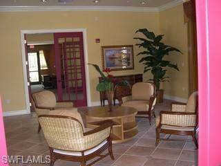 8490 Kingbird Loop, Unit 934 Estero, FL 33967 - Photo 13 of 26 a living room with furniture a rug and a potted plant