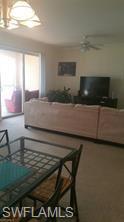 8490 Kingbird Loop, Unit 934 Estero, FL 33967 - Photo 16 of 26 a living room with furniture and a flat screen tv