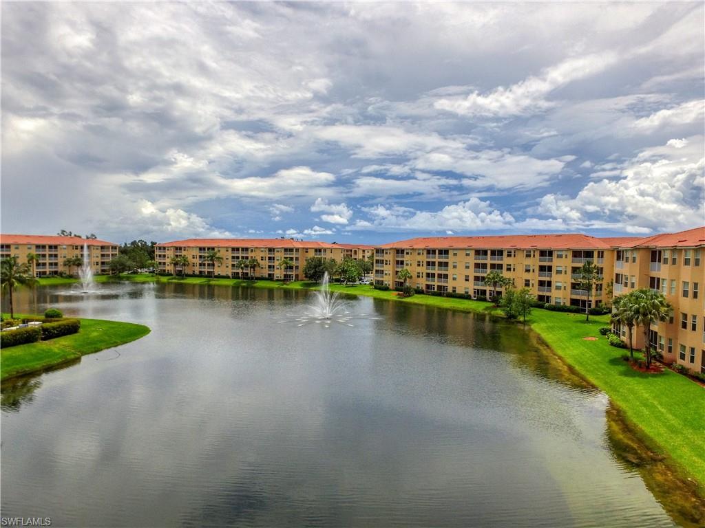 8490 Kingbird Loop, Unit 934 Estero, FL 33967 - Photo 2 of 26 a view of a lake with houses in the back