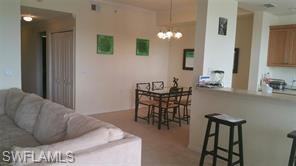 8490 Kingbird Loop, Unit 934 Estero, FL 33967 - Photo 22 of 26 a living room with furniture and a potted plant
