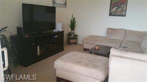 8490 Kingbird Loop, Unit 934 Estero, FL 33967 - Photo 23 of 26 a bedroom with a bed and a television