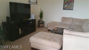 8490 Kingbird Loop, Unit 934 Estero, FL 33967 - Photo 24 of 26 a room with furniture and a flat screen tv