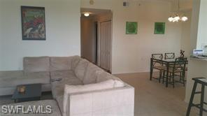 8490 Kingbird Loop, Unit 934 Estero, FL 33967 - Photo 25 of 26 a living room with furniture and a table