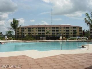 8490 Kingbird Loop, Unit 934 Estero, FL 33967 - Photo 6 of 26 a view of a swimming pool with a garden