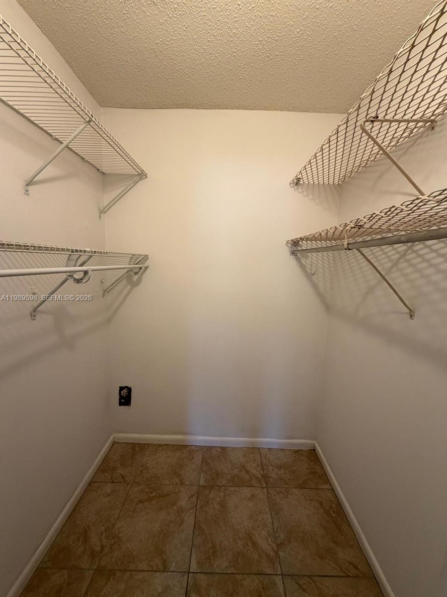 253 South Cypress Road, Unit 214 Pompano Beach, FL 33060 - Photo 12 of 25 a view of a room with racks on the wall