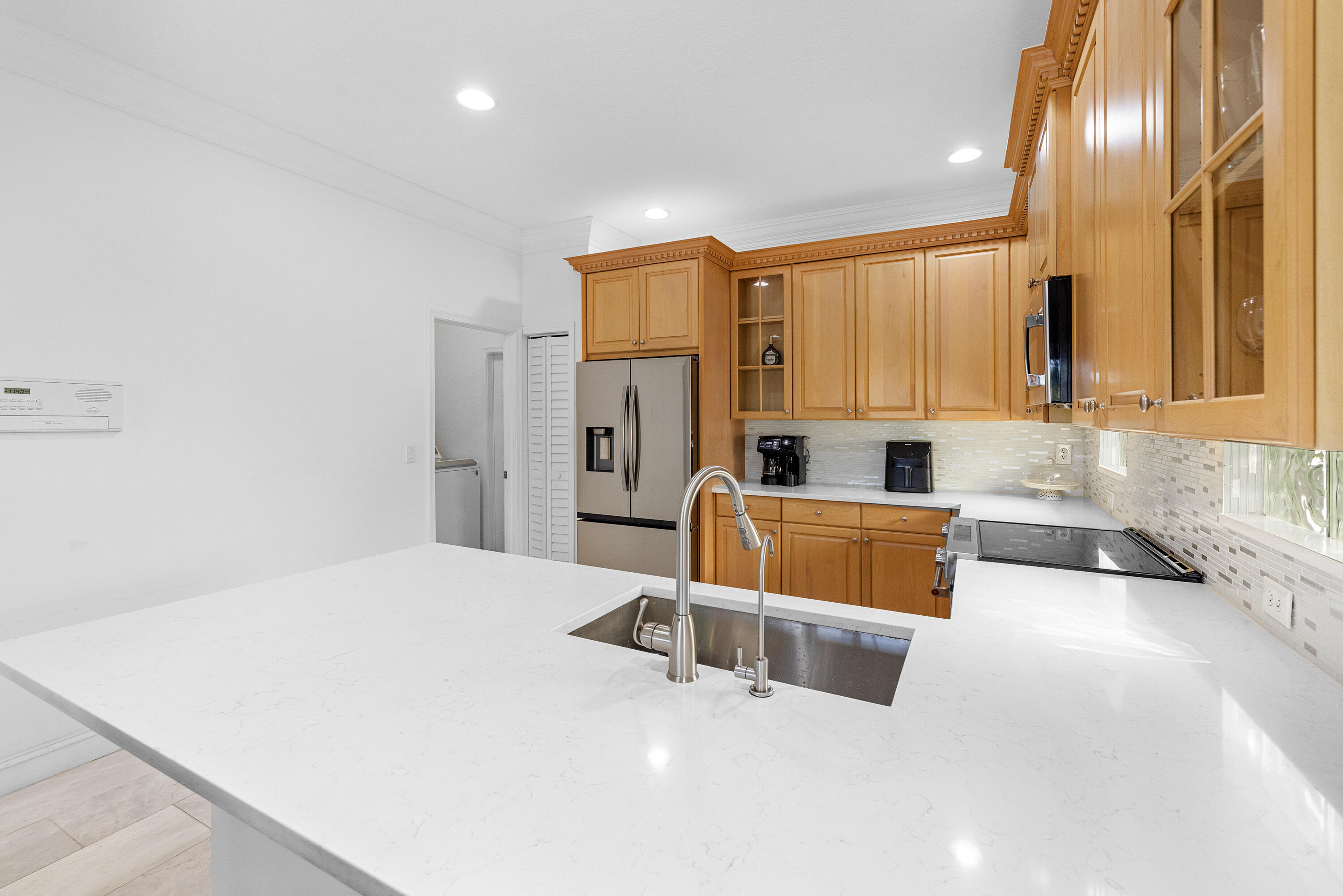 6575 Spring Meadow Drive Greenacres, FL 33413 - Photo 13 of 54 a large white kitchen with a large window
