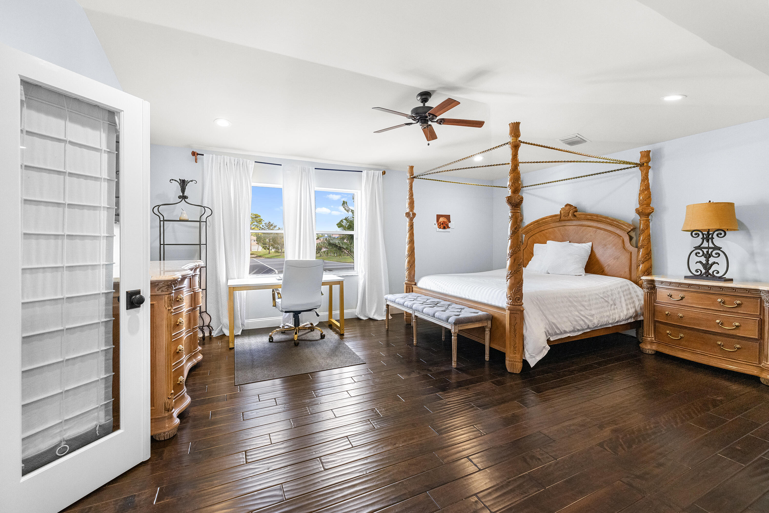 6575 Spring Meadow Drive Greenacres, FL 33413 - Photo 17 of 54 a bedroom with a bed furniture and wooden floor