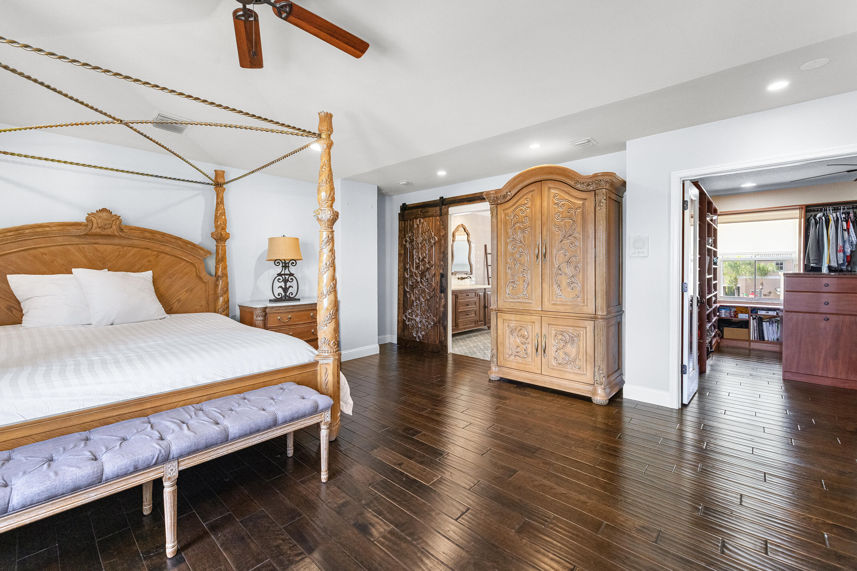 6575 Spring Meadow Drive Greenacres, FL 33413 - Photo 18 of 54 a spacious bedroom with a bed and wooden floor