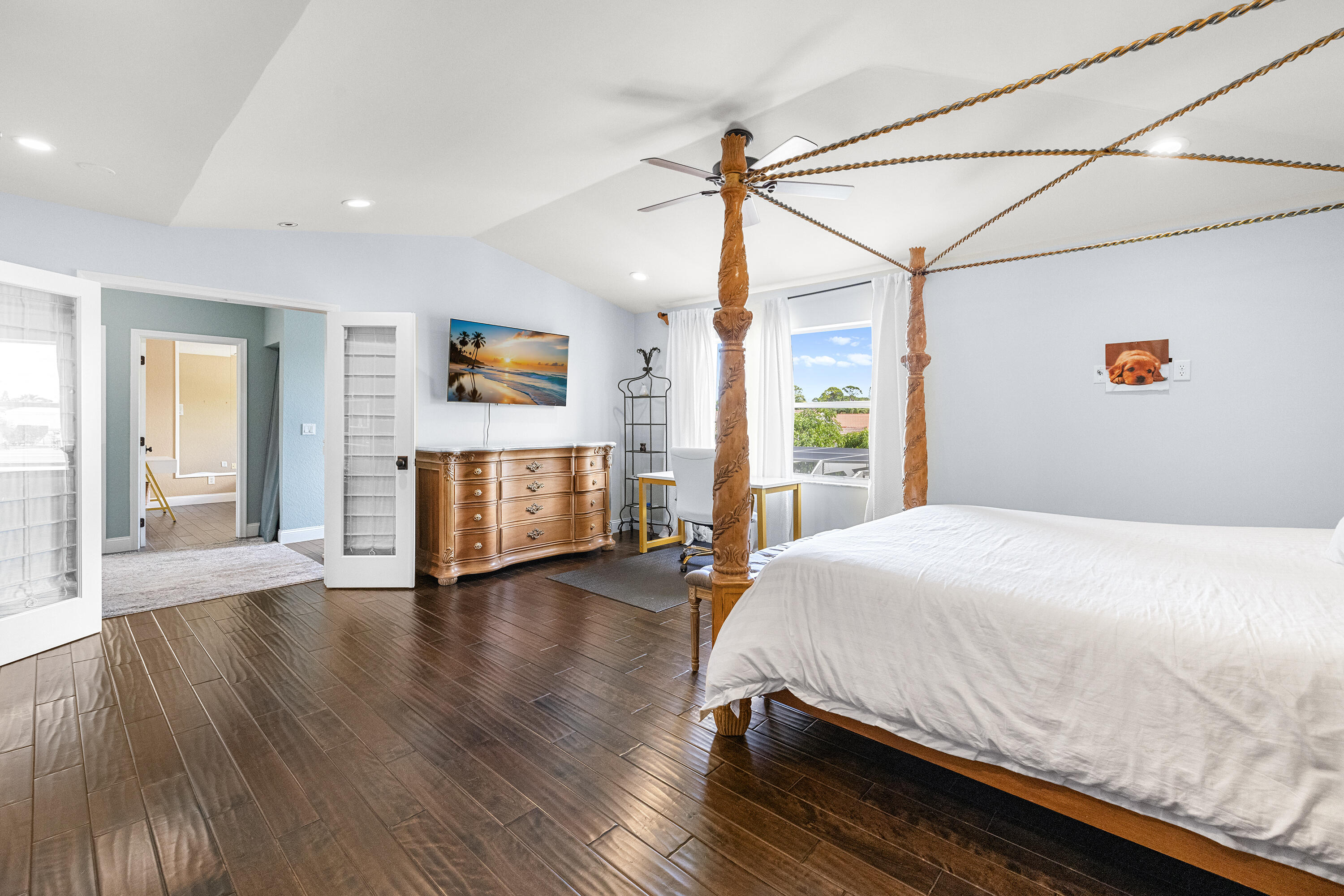 6575 Spring Meadow Drive Greenacres, FL 33413 - Photo 19 of 54 a bedroom with a bed and wooden floor