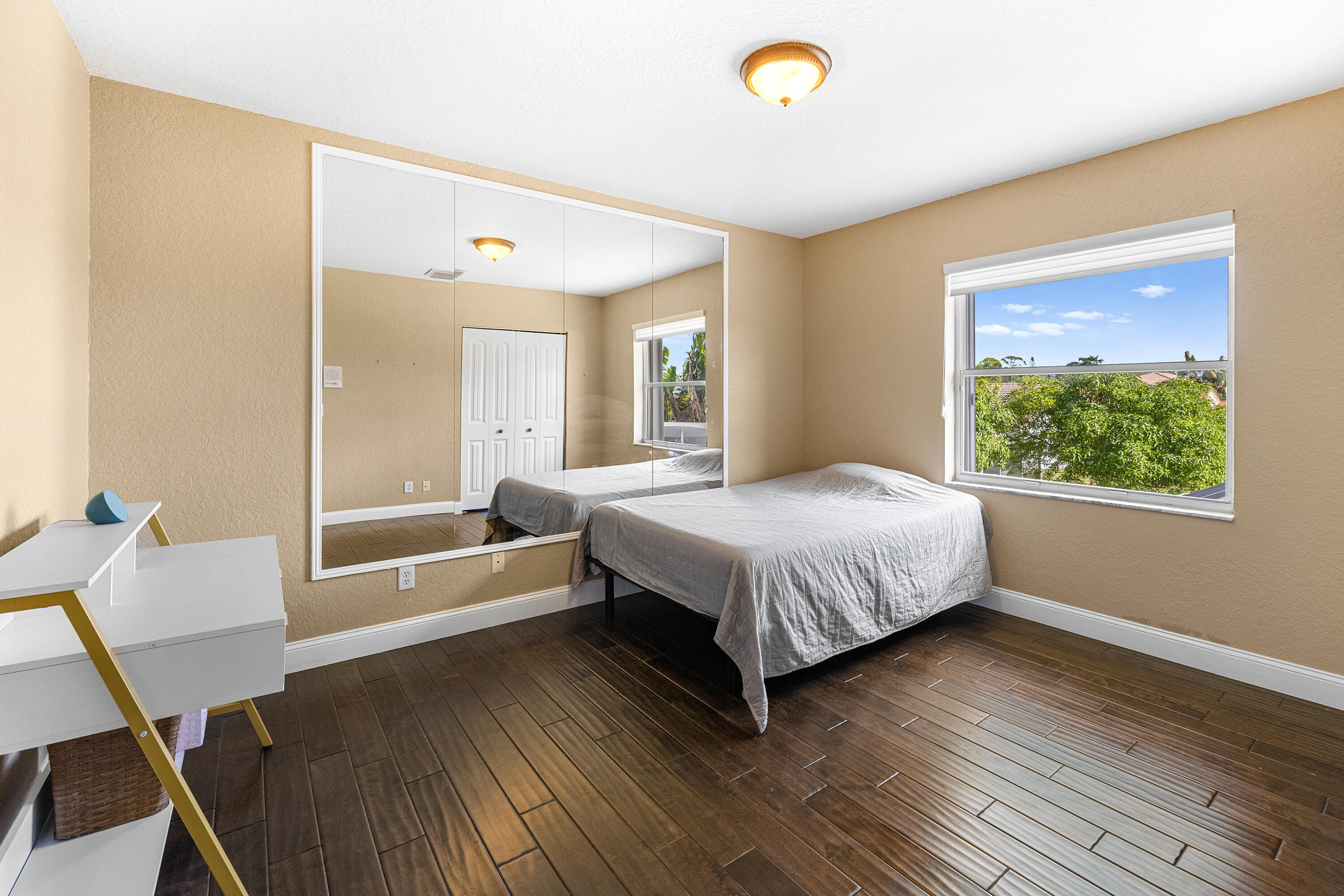 6575 Spring Meadow Drive Greenacres, FL 33413 - Photo 26 of 54 a bedroom with a bed and a window