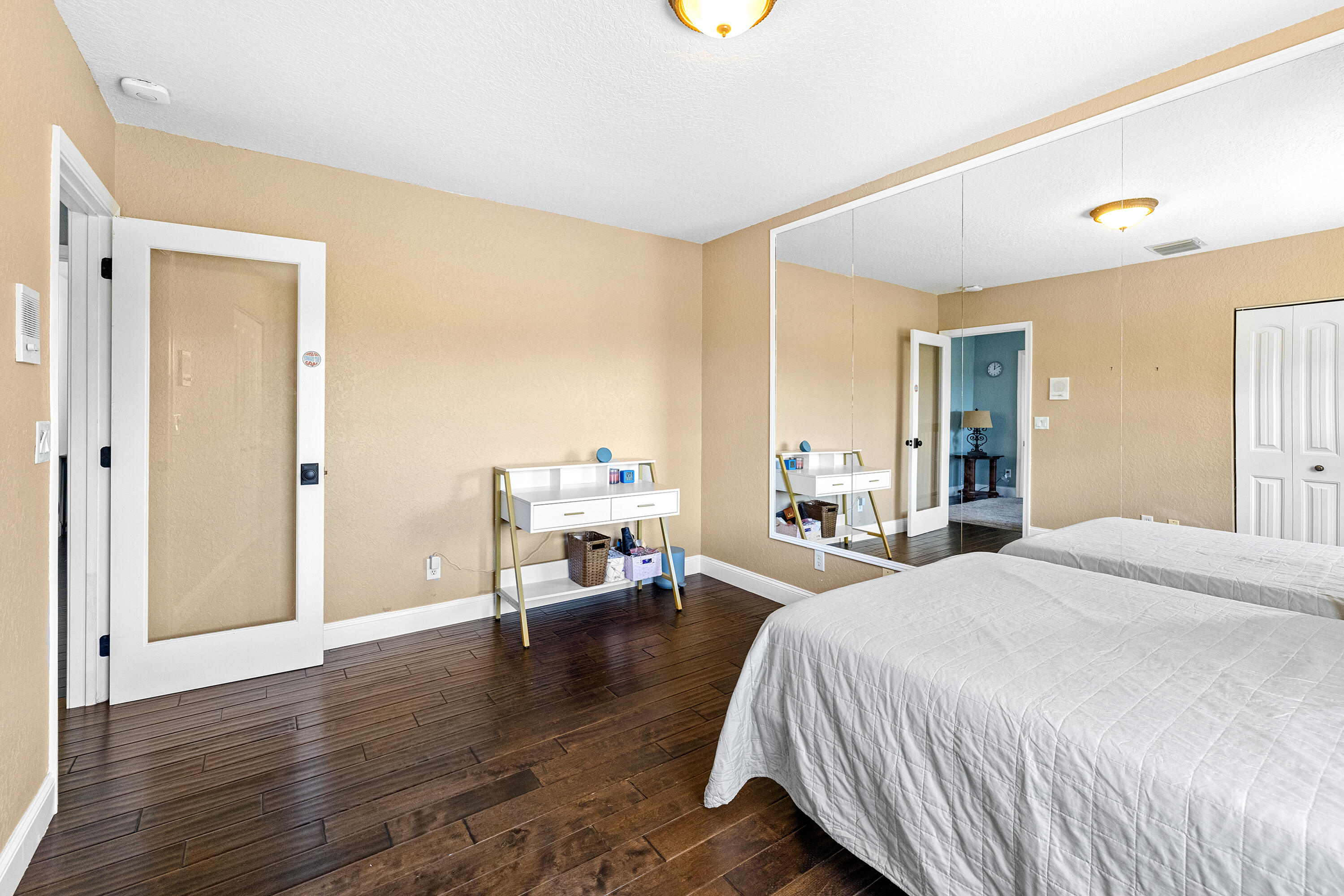 6575 Spring Meadow Drive Greenacres, FL 33413 - Photo 27 of 54 a spacious bedroom with a bed and a table in it