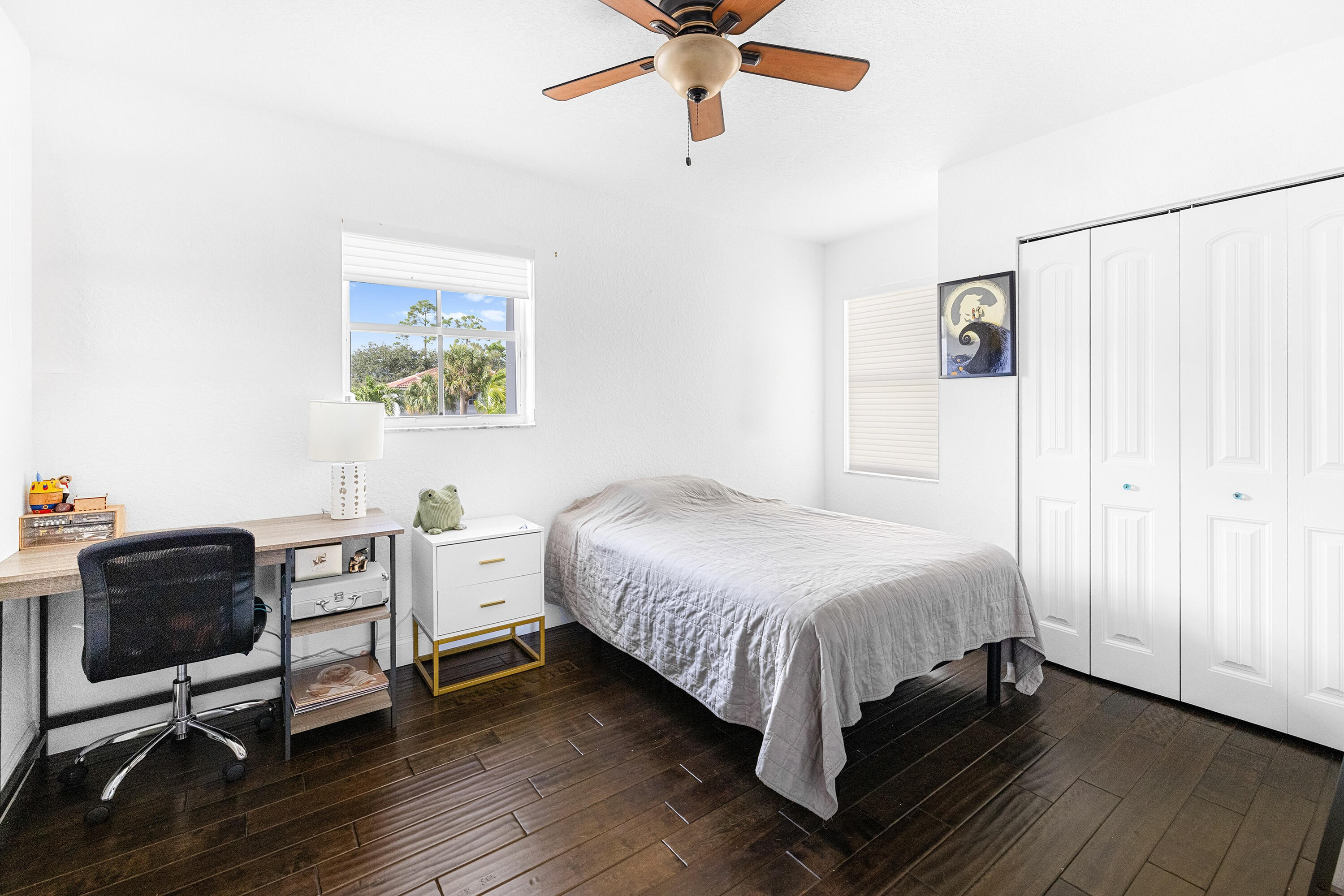 6575 Spring Meadow Drive Greenacres, FL 33413 - Photo 29 of 54 a bedroom with a bed and a chandelier